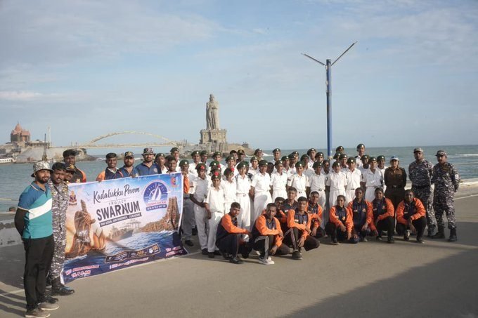 Senior officers in naval camouflage reviewing the expedition team
