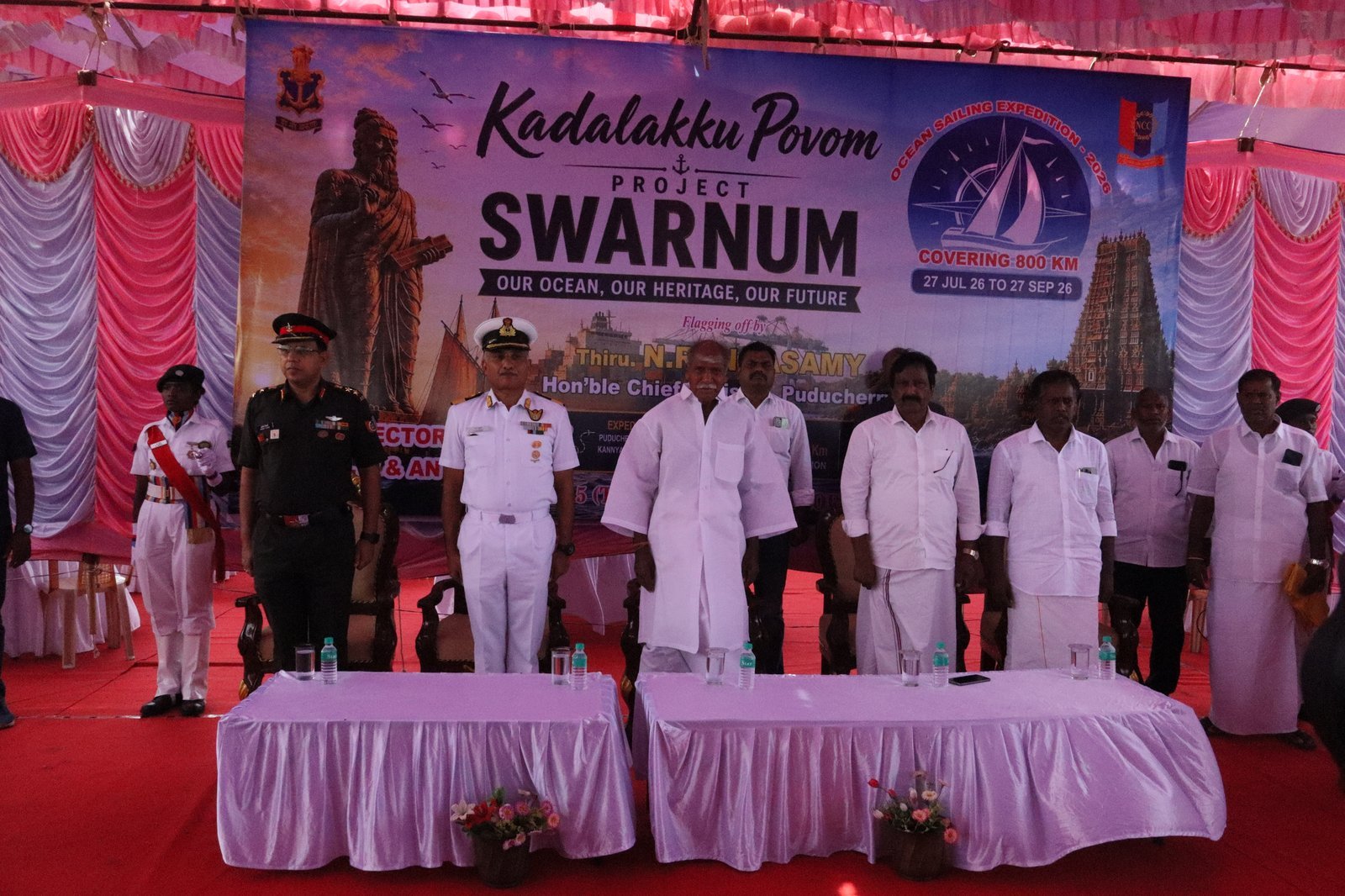 Dignitaries — Army, Navy officers and elected representatives — assembled in front of the Project SWARNUM backdrop