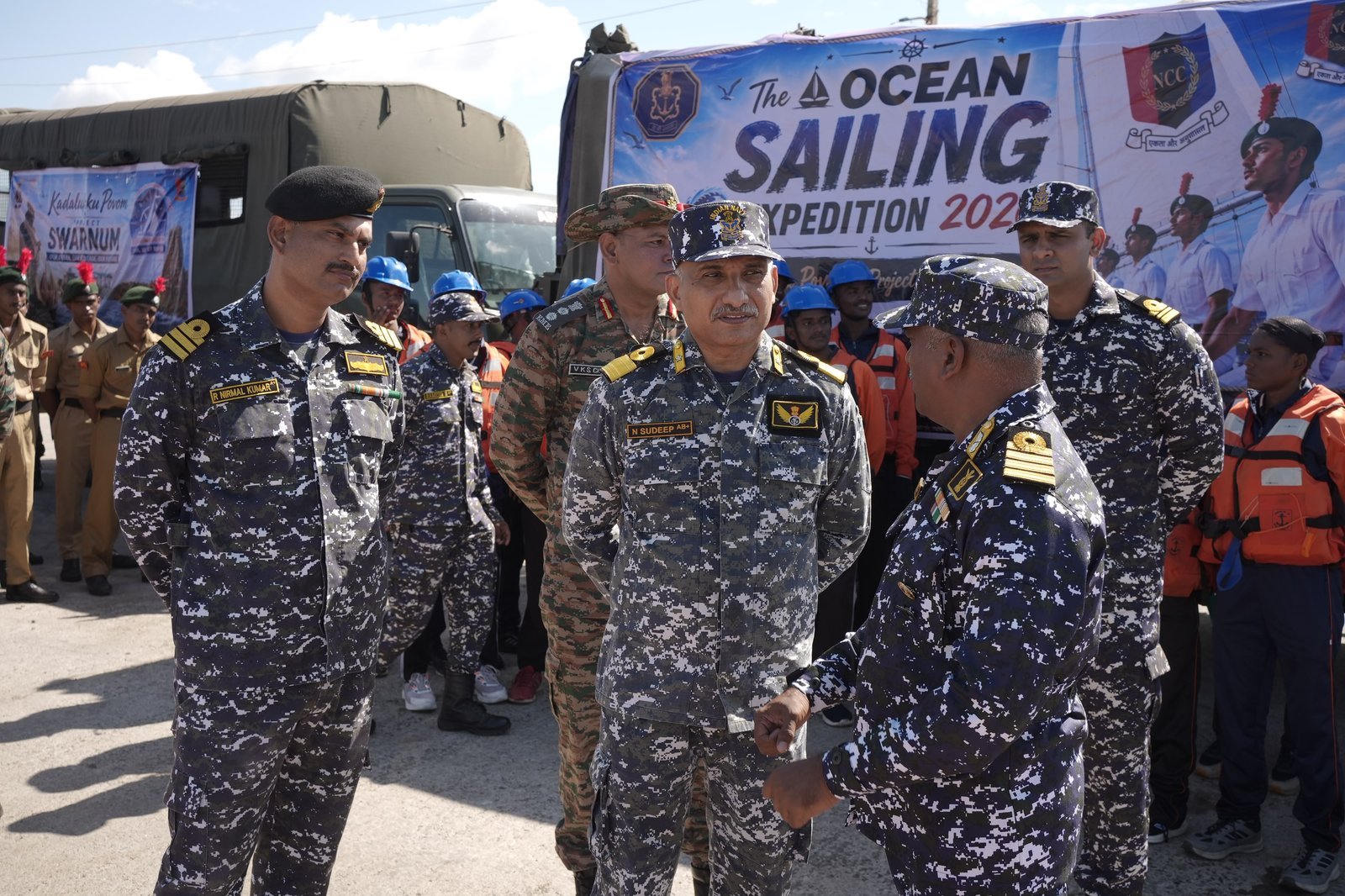 Commander Sudeep Nambiat with fellow naval and army officers in front of the Ocean Sailing Expedition 2026 backdrop